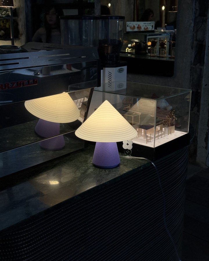 NOLA lamp glowing on a café counter at night