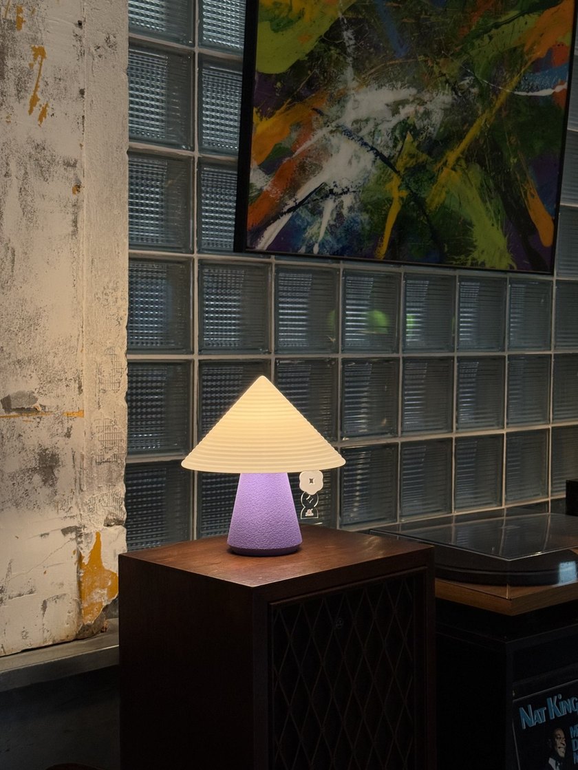 NOLA lamp glowing warmly in an eclectic living space